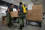 Soldiers don exoskeleton suits to prepare 2024 NDP packs