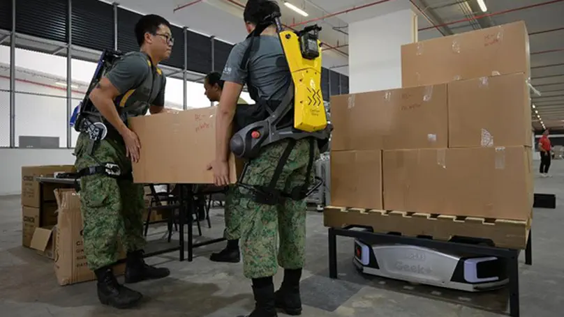 Soldiers don exoskeleton suits to prepare 2024 NDP packs